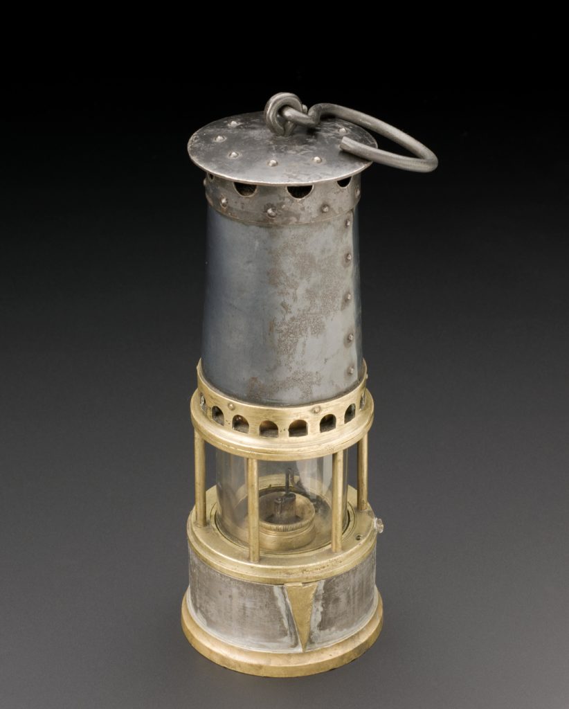 Colour photograph of a late nineteenth century miners safety lamp