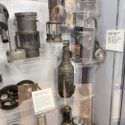 Colour photographs of coal miners safety lamps on display in a museum exhibition
