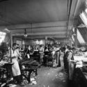Black and white photograph of workers in a pattern printing and cutting room