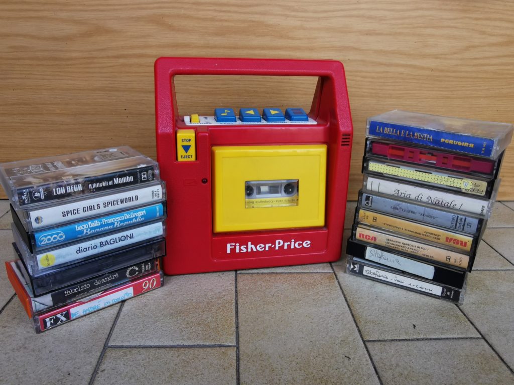 Colour photograph of a Fisher Price cassette player with cassette tapes