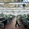Photograph of a male worker in a worsted cloth weaving shed