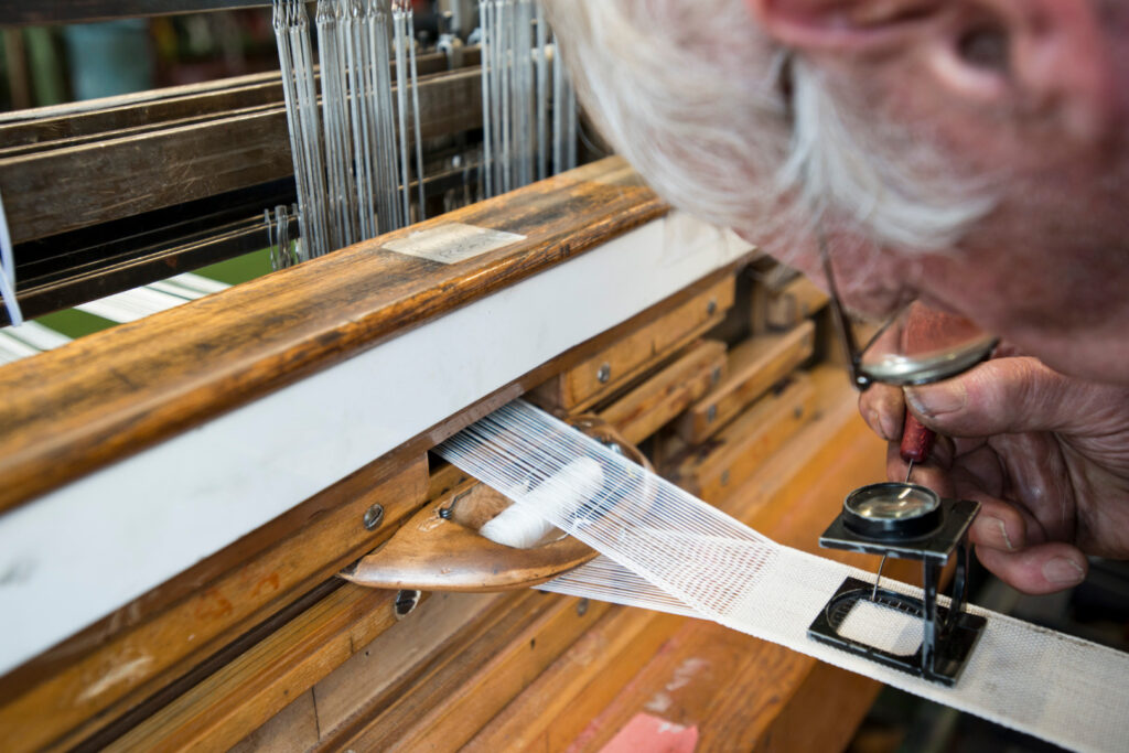 Photograph of a man weaving silk for replacement knee cartilage