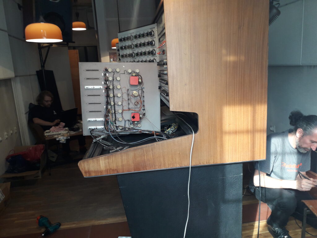 Colour photograph of Daniel Araya and Jari Suominen fixing the Synthi 100 in Belgrade