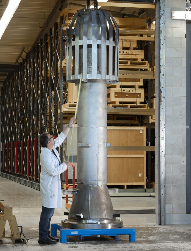 Colour photograph of National Museums Scotland Conservator Stuart McDonald sizing up the flare tip from the Murchison Oil Platform