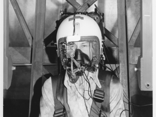 Black and white photograph of Phil Catling wearing equipment to test eye tracking ability under vibration in 1975