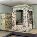 Colour photograph of the Garrick Bed with Indian chintz on display in a museum