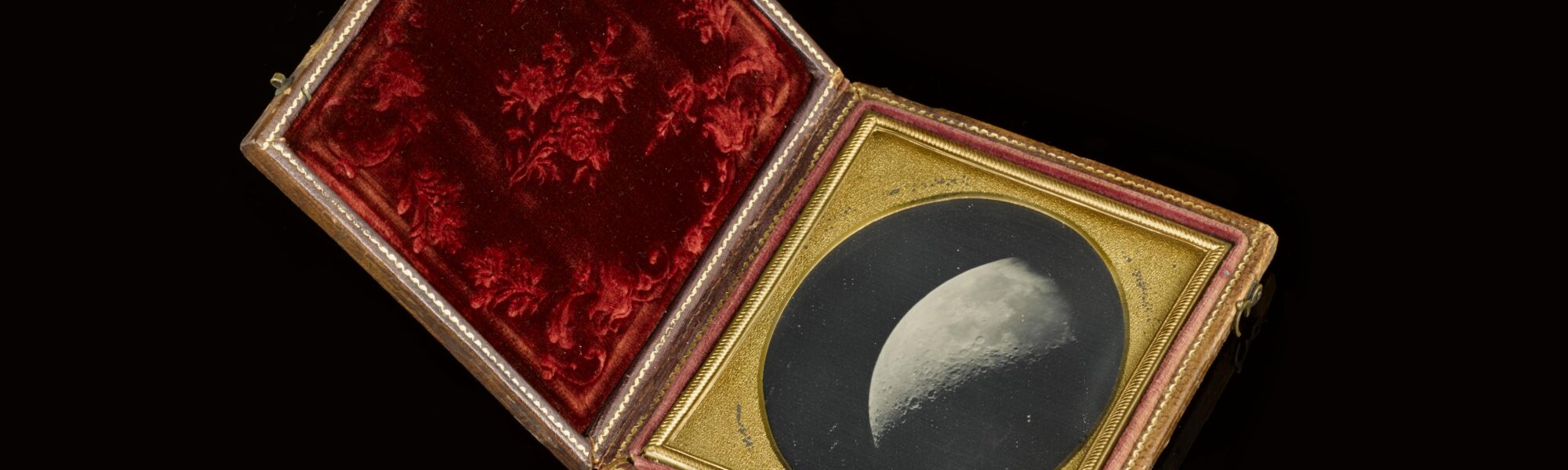 Colour photograph of a framed Daguerreotype of the Moon