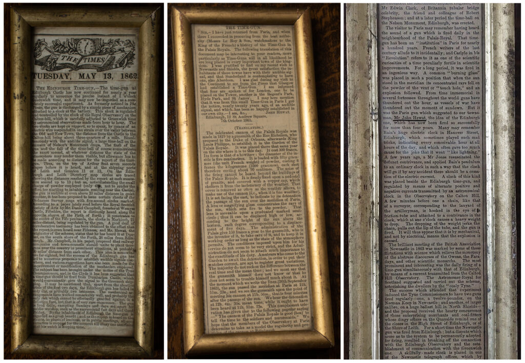 Photographs of framed newspaper clippings mounted at the back of the model time ball and gun