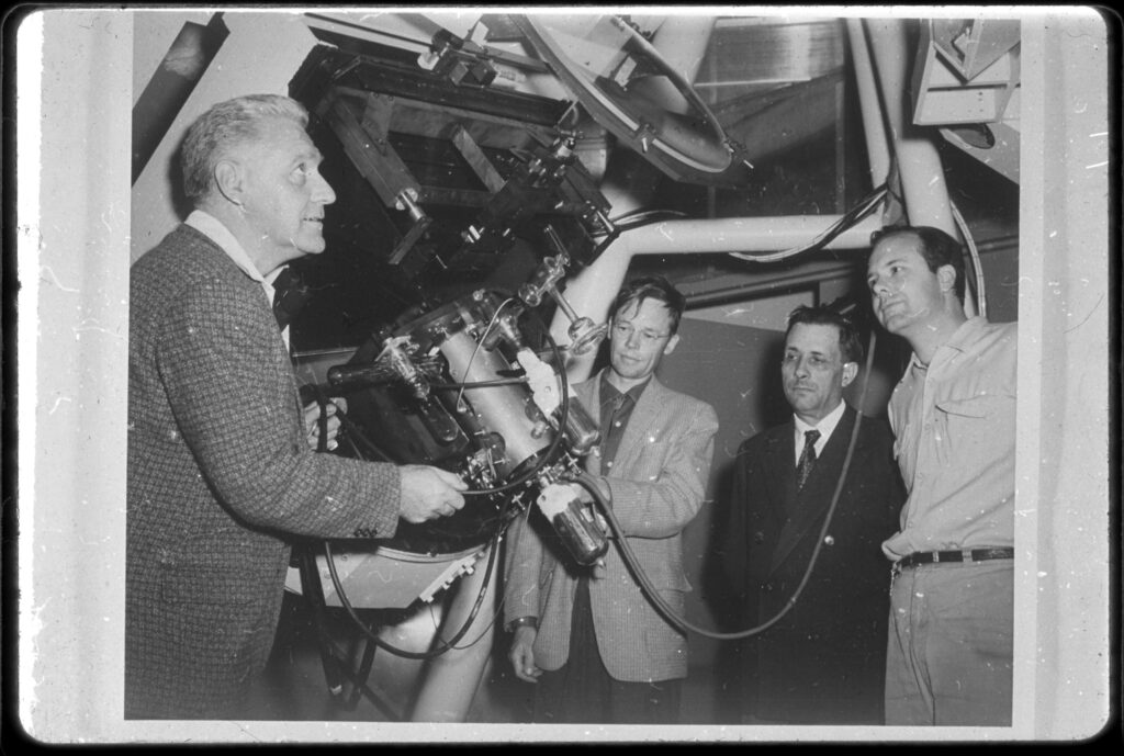 Black and white photograph of Lallemand attaching his electronic camera to the 120 inch telescope