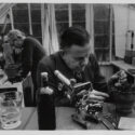 Monochrome photograph of Kate and Percy Smith working in a greenhouse laboratory