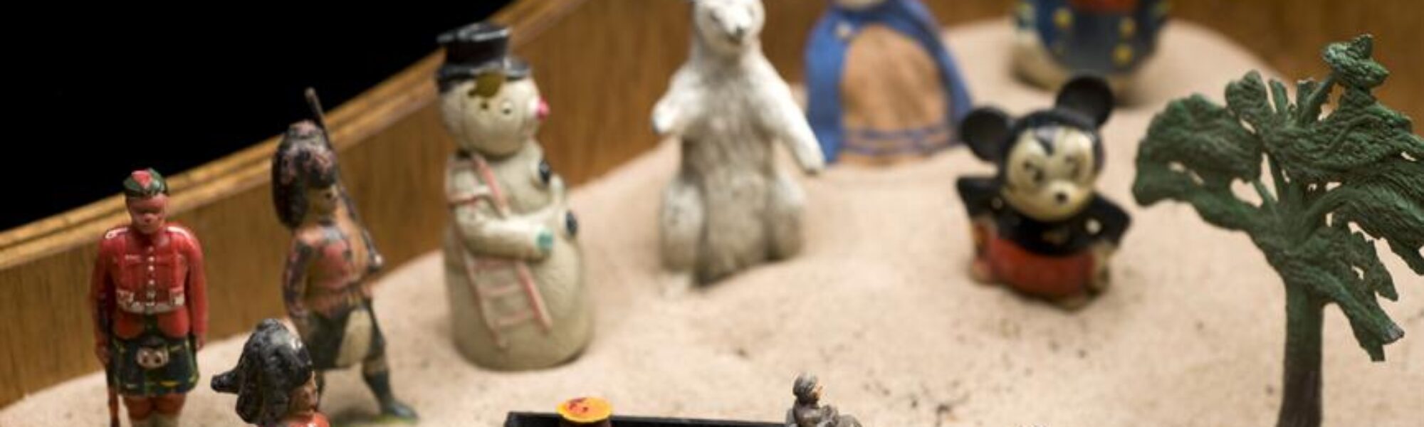 Colour photograph of childrens toys in a sandbox