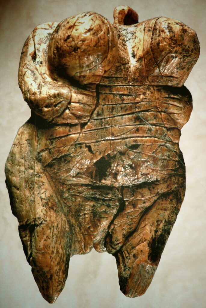 Colour photograph of an acient venus figurine made of mammoth ivory