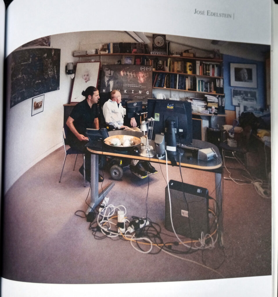 Photograph of Stephen Hawking in conversation in his office