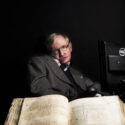 Stephen Hawking with an original book by Isaac Newton